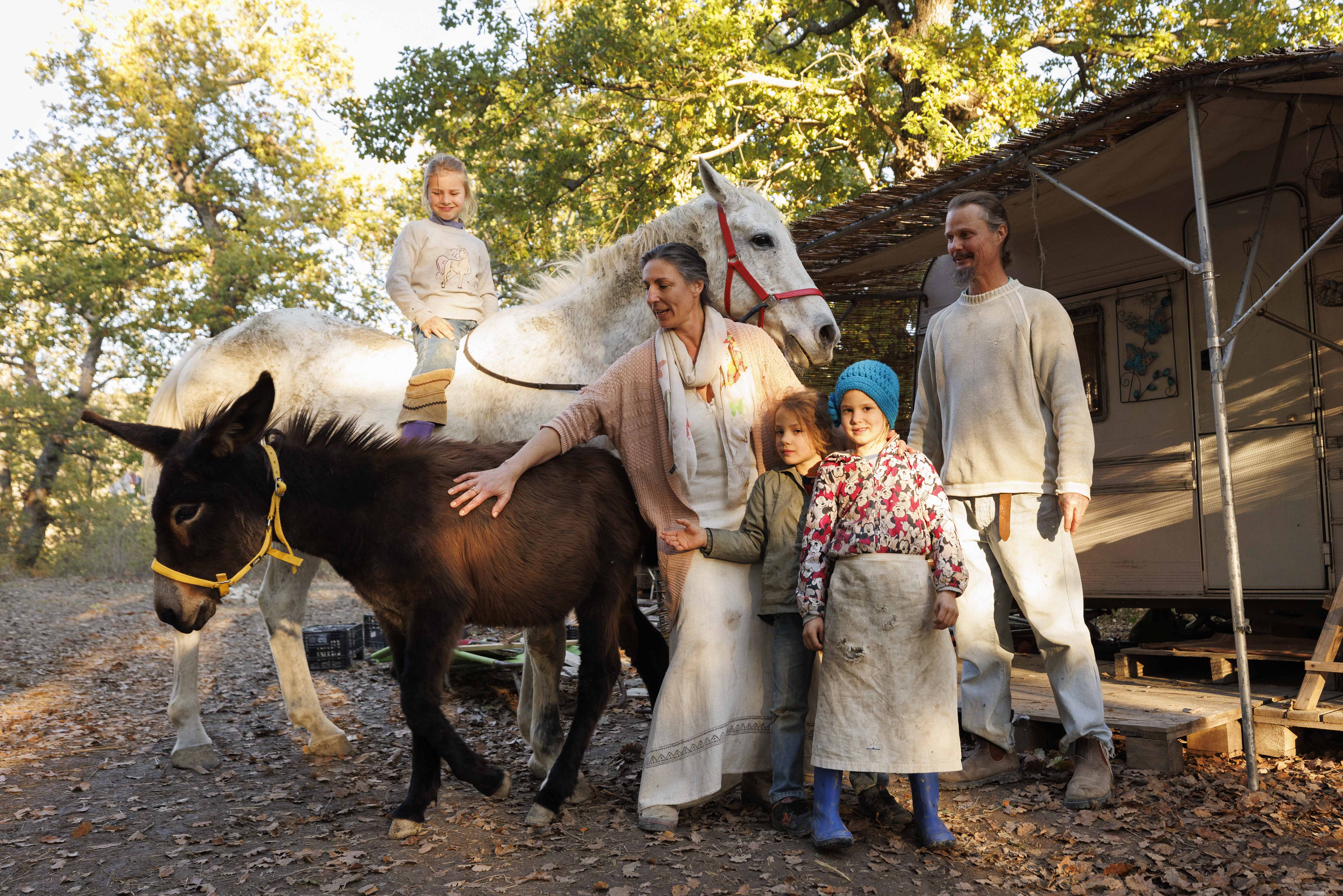 Family with three children and animals in the Italian countryside.