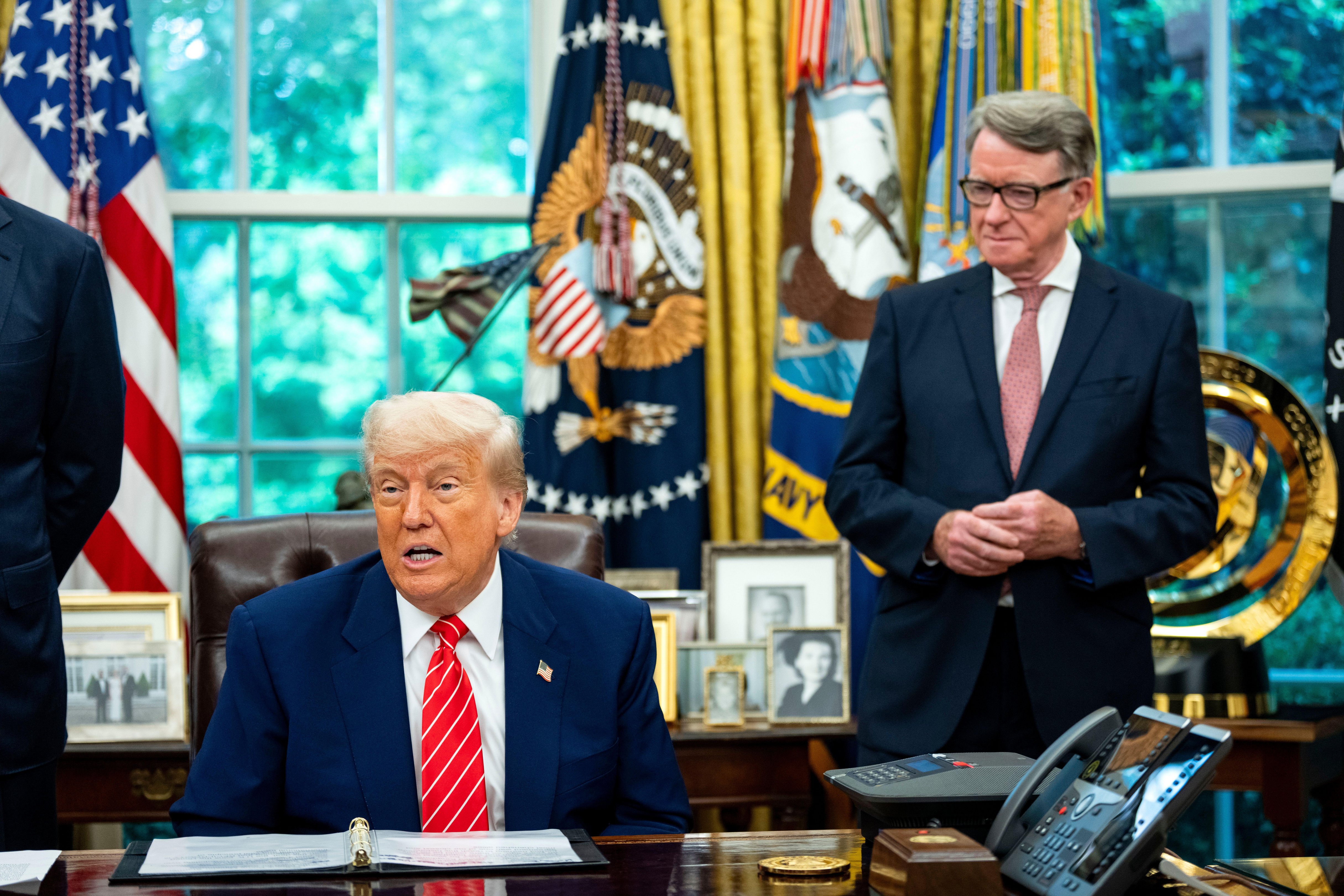 US President Donald Trump announces a trade agreement with the UK as Ambassador Peter Mandelson looks on.