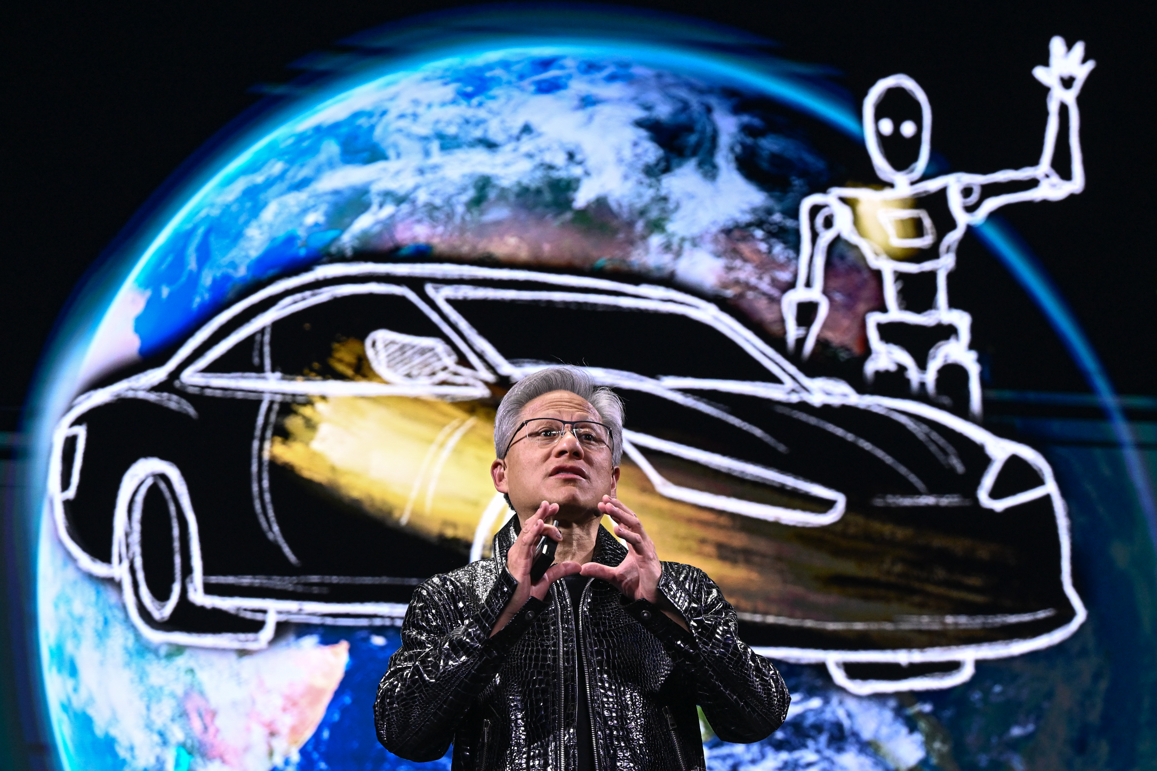 NVIDIA CEO Jensen Huang presenting at CES 2025 with a screen showing the Earth, a sketch of a car, and a robot in the background.