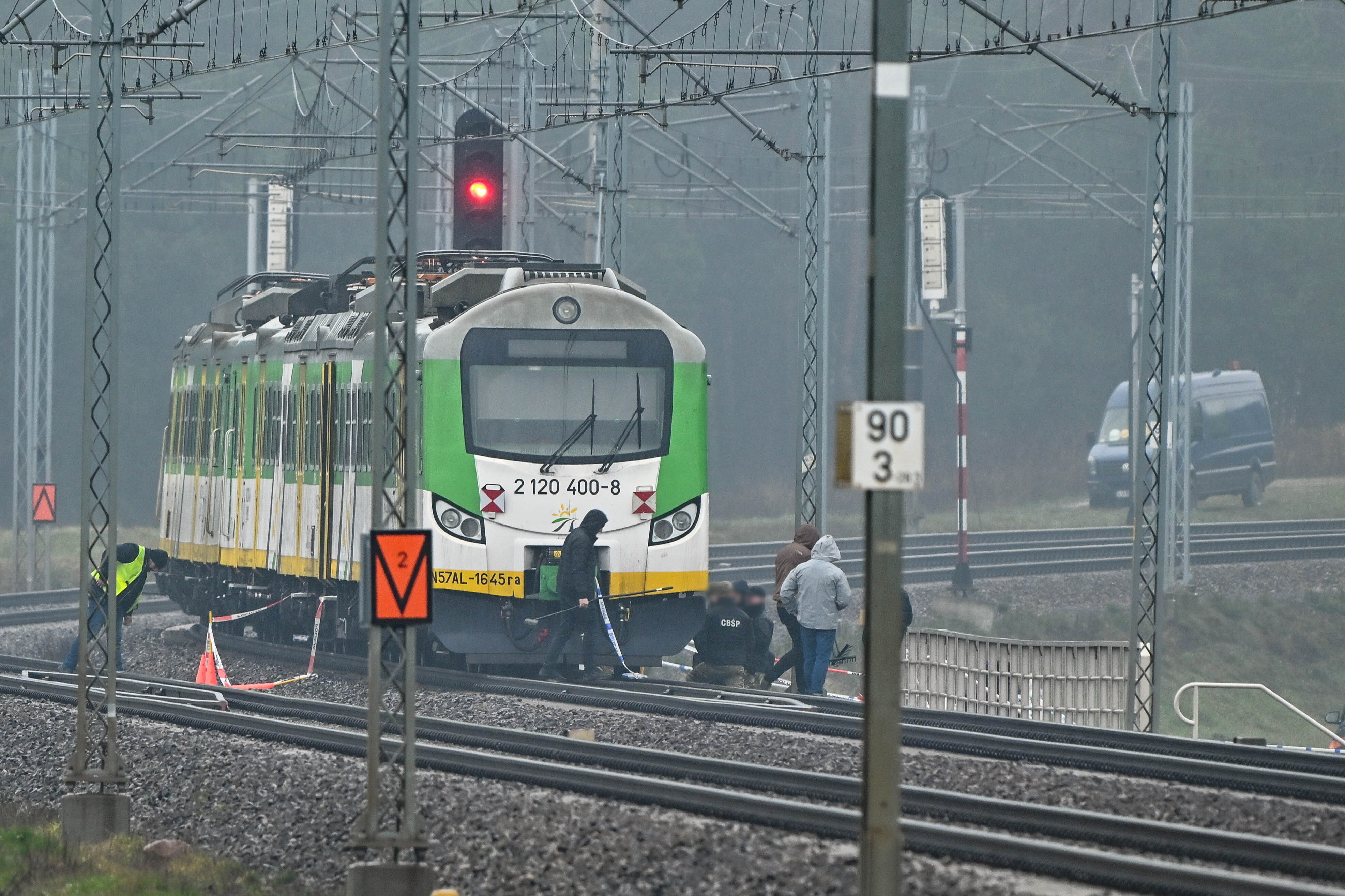 Police and special forces investigate a destroyed section of railway tracks on the Deblin-Warsaw route.