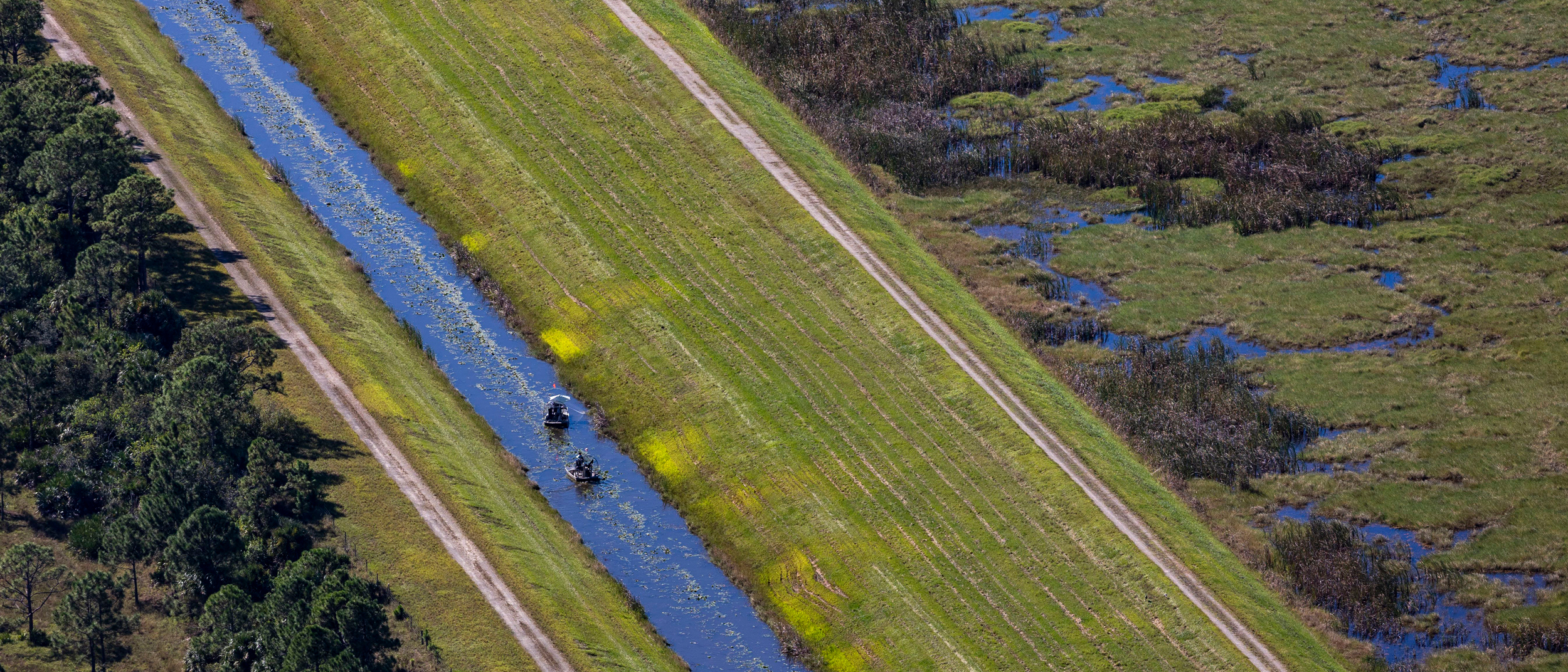Two airboats traverse a canal in the Everglades. Credit: Jose Iglesias/Miami Herald