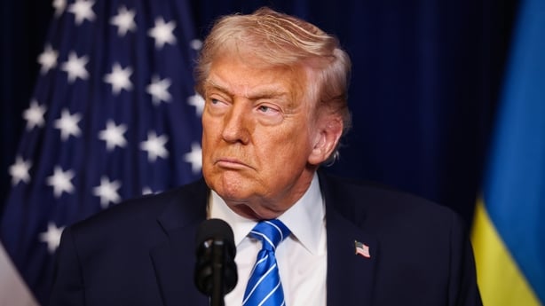 U.S. President Donald Trump listens during a press conference with Ukrainian President Volodymyr Zelensky following their meeting at Trump's Mar-a-Lago club