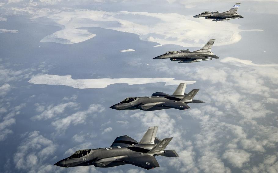 Four fighter jets in formation.