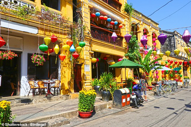 Travel through the colourful backstreets of capital city Hanoi on a Vespa