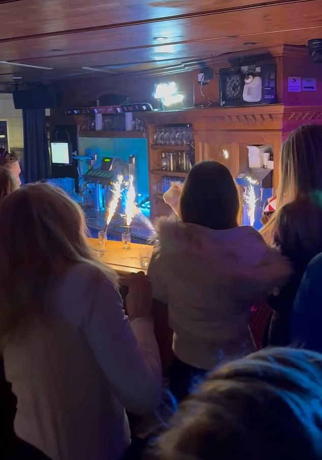 Exclusive footage, obtained by the Daily Mail, shows revellers blissfully dancing shoulder-to-shoulder at the five-star Elizabeth Arthotel's popular Schatzi bar, in Ishgl, Austria, where drinks sparklers can be seen on the counter