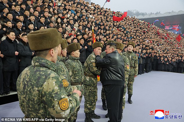 Pictured: Kim Jong Un praising the young personnel who were dispatched to overseas special military operations at the 80th anniversary of the founding of the Socialist Patriotic Youth League, at Kim Il Sung Stadium in Pyongyang