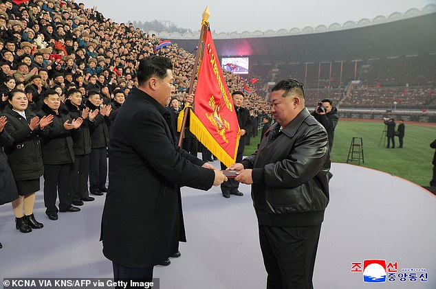 Pictured: Kim Jong Un presenting the certificate for the Order of Kim Jong Il to Mun Chol, the chairman of the Socialist Patriotic Youth League
