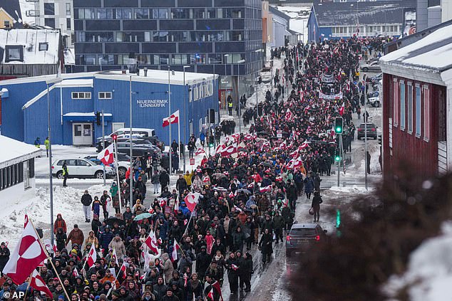 A crowd walks to the US consulate to protest against Trump's policy towards Greenland in Nuuk, Greenland, Saturday, Jan. 17, 2026