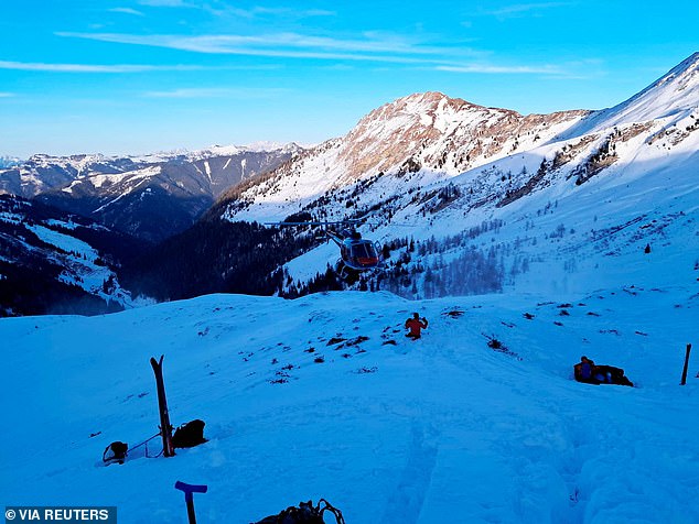 A helicopter hovers near the site where four skiers were killed in an avalanche in the Pongau district, Austria, January 17, 2026