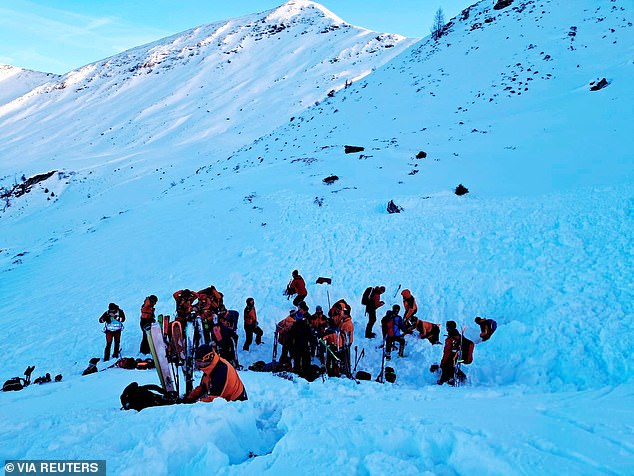 Rescue workers stand near the site where four skiers were killed in an avalanche in Pongau district, Austria, January 17, 2026