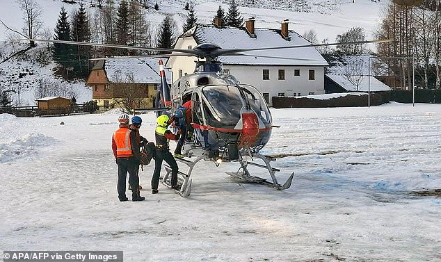 Members of the Mountain Rescue board a helicopter in Pusterwald, Austria on January 18, 2026 as rescure efforts continue following two avalanches in the Alps in Austria the day before