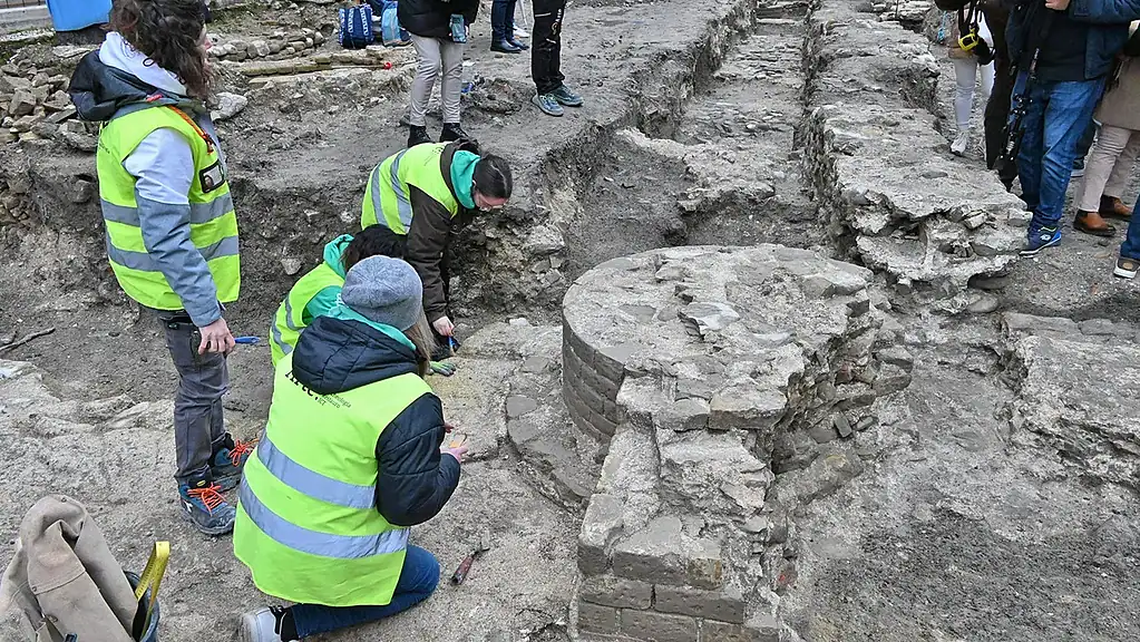 Excavation of ancient ruins by archaeologists during an excavation site investigation.