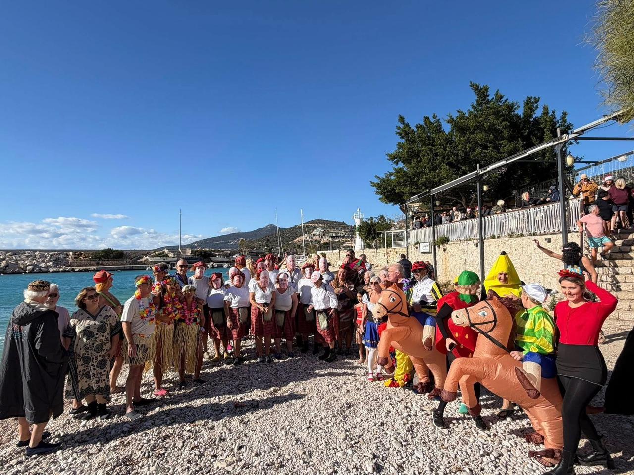Members of the expatriate community enter the Mediterranean in unusual costumes and then line up on the shore for a group photograph as part of a New Year tradition in southern Türkiye, Jan. 2, 2026. (AA Photo)