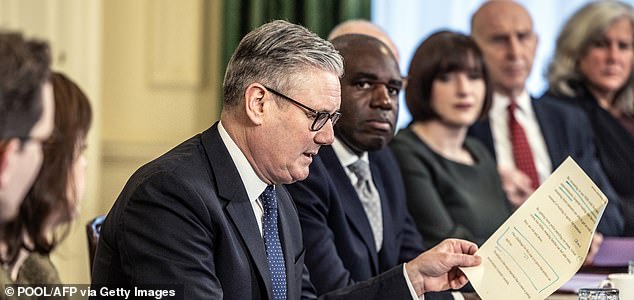 Britain's Prime Minister Keir Starmer (C) speaks to members of his political Cabinet at the start of the first cabinet meeting of the new year inside 10 Downing Street in central London on January 6, 2026. (Photo by RICHARD POHLE / POOL / AFP via Getty Images)