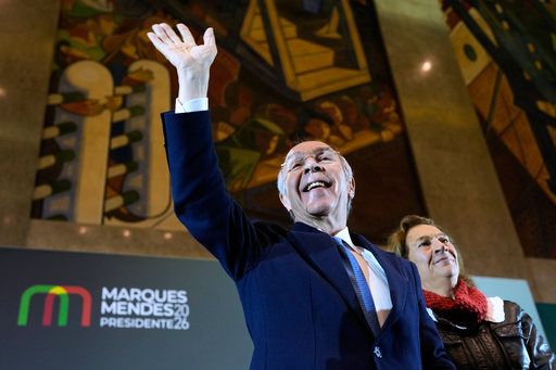 Portugal’s presidential election may deliver another gain for populists in Europe Presidential candidate Luis Marques Mendes, from the center-right Social Democratic Party, with his wife Rosa Sofia Salazar, gestures to supporters while campaigning for Sunday