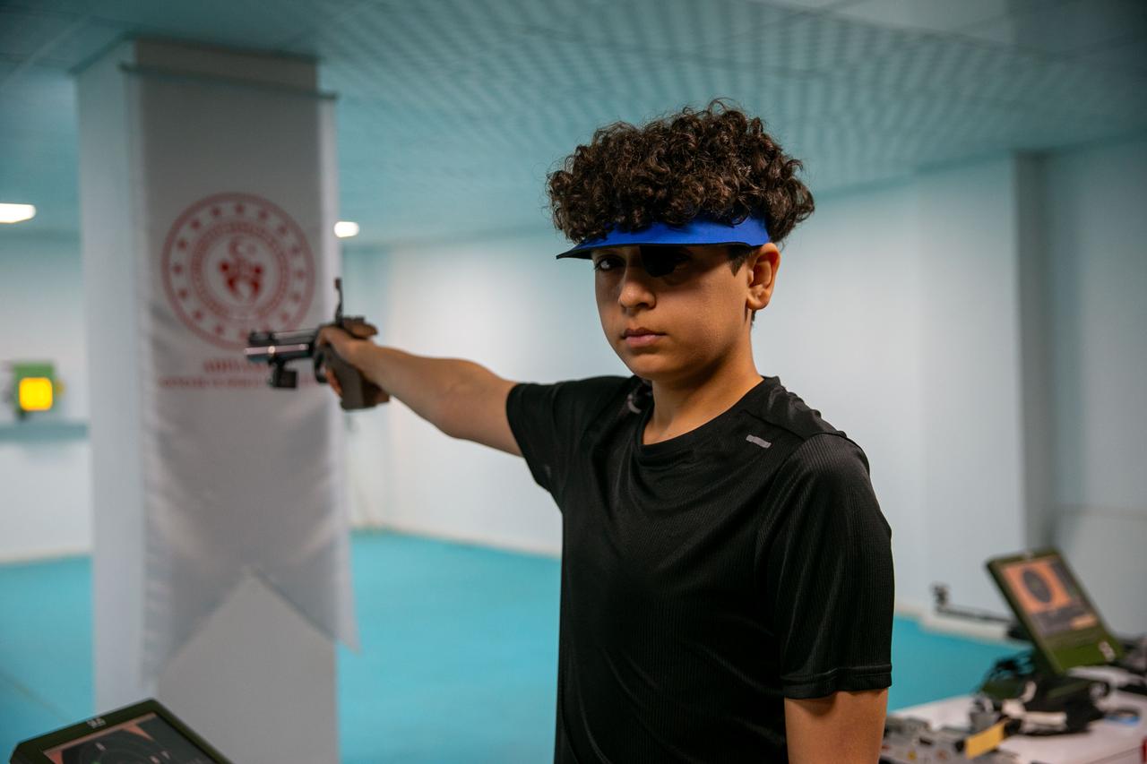 Mehmet Ali Kaya trains in the air pistol discipline at an indoor shooting range in Adiyaman, focusing on precision and stability during practice sessions organized by local sports authorities. (AA Photo)