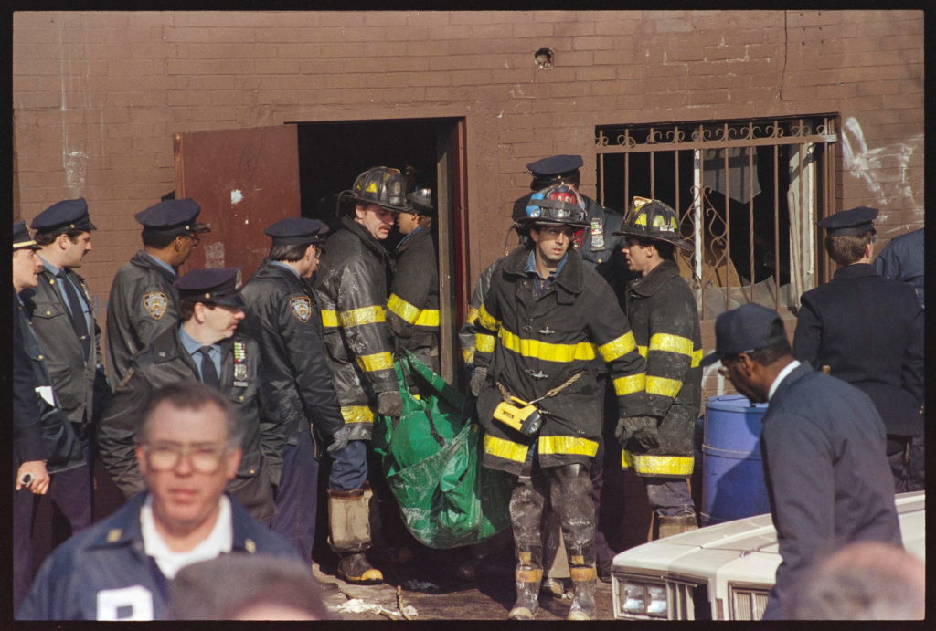 Firemen bring out a body from Happy Land Nightclub in the Bronx after fire claimed 87 lives.