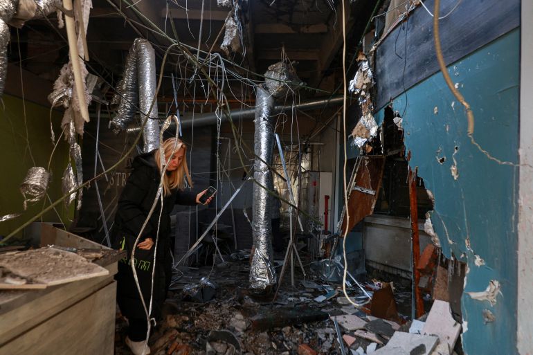 A woman walks on debris inside a gym situated in a building of Professional Lyceum of Construction and Architecture which was hit by a Russian drone strike, amid Russia's attack on Ukraine, in Odesa, Ukraine January 13, 2026. REUTERS/Nina Liashonok TPX IMAGES OF THE DAY
