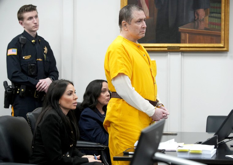 paul caneiro stands inside of a courtroom