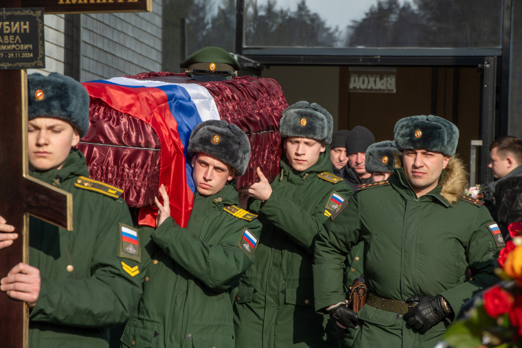 Servicemen carry a coffin during the funeral of a serviceman of the Russian army