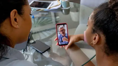 Getty Images Patient using phone for remote consultation