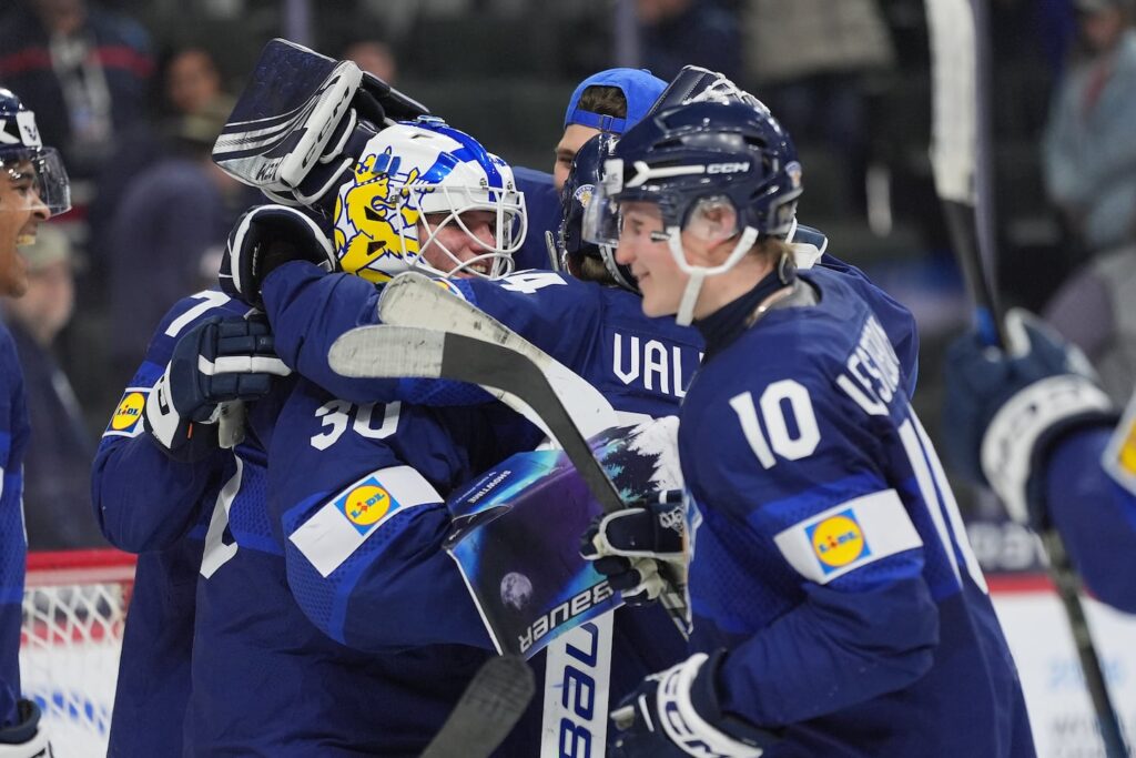 Two-time defending champs stunned in quarterfinals Finland goalie Petteri Rimpinen (30) (left) celebrates with teammates after an overtime win against the United States in the IIHF World Junior Hockey Championship quarterfinals in St. Paul.