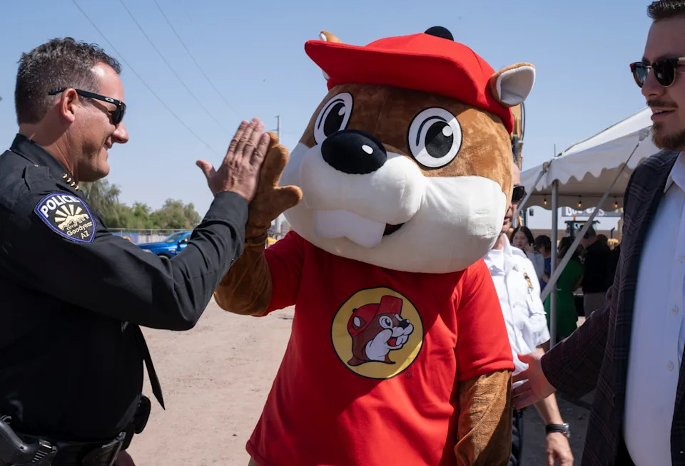 Buc-ee the beaver (right) high-fives Goodyear Police Chief Brian Issitt (left) during the Buc-ee's Arizona groundbreaking ceremony at 1001 N. Bullard Ave., in Goodyear, Arizona, on May 14, 2025.