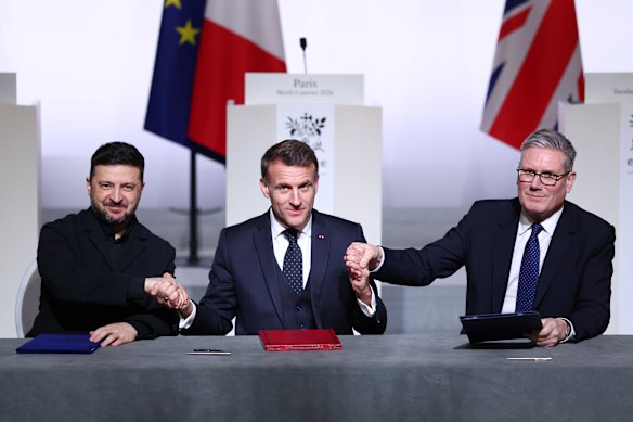 Presidents Volodymyr Zelensky of Ukraine and Emmanuel Macron of France, and British Prime Minister Keir Starmer attend a signing ceremony during a “Coalition Of The Willing” meeting on the Ukraine war in Paris on Tuesday.