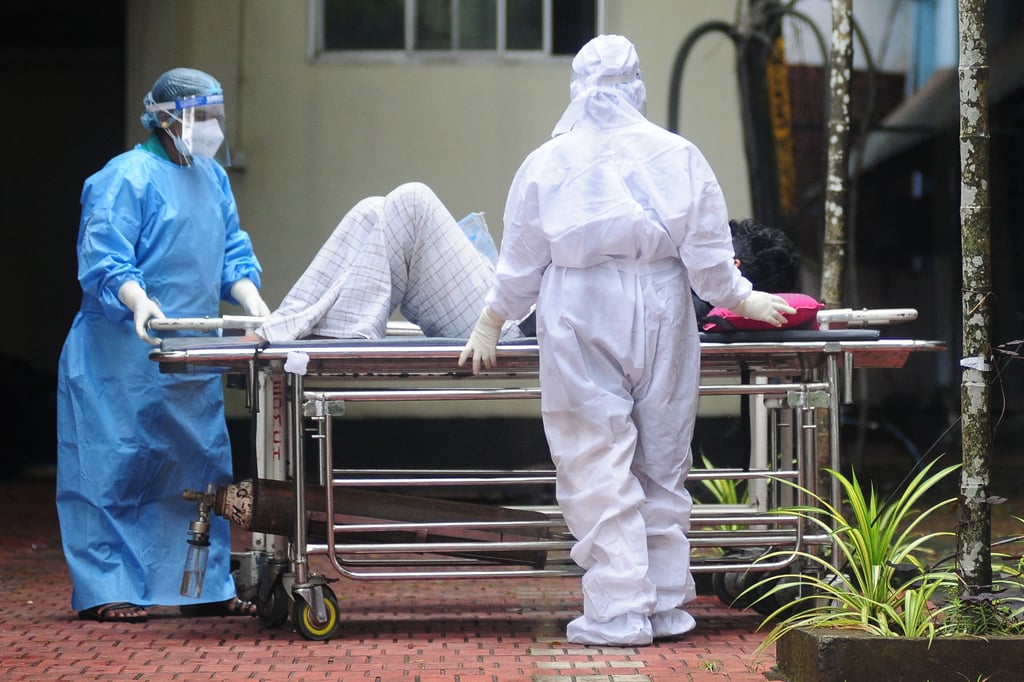 Healthcare workers in the southern Indian state of Kerala wear protective gear as they attend to a man with symptoms of the Nipah virus in September 2023. Photo AFP