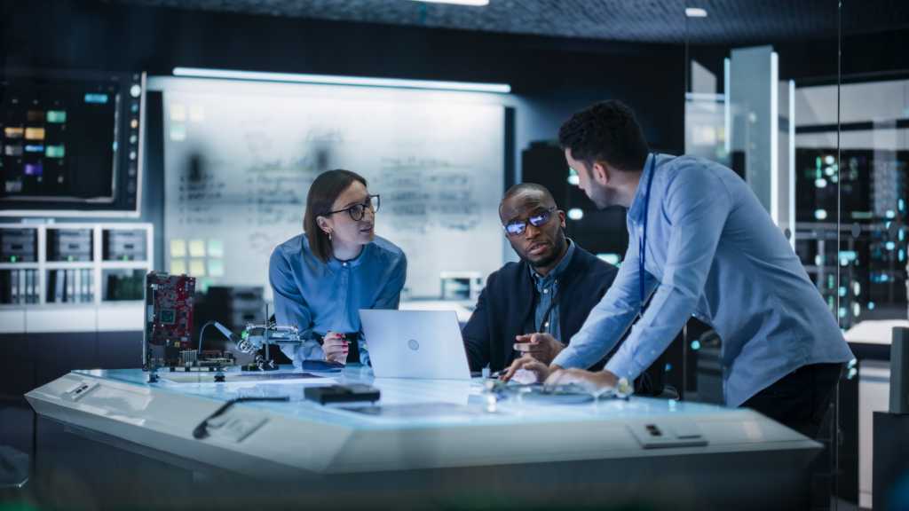 Diverse group industrial robotics specialists gathered