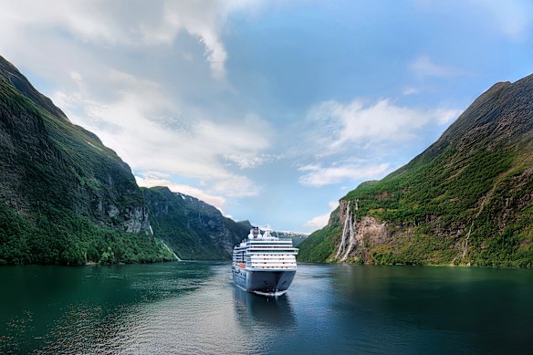 Holland America’s MS Rotterdam sails through a fjord.