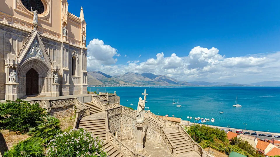 Gaeta, Italy. August 12th, 2017. View of Gaeta from the Church of San Francesco. This church is located in the historic center of the city and was built starting in 1283. Stairway and Statue.