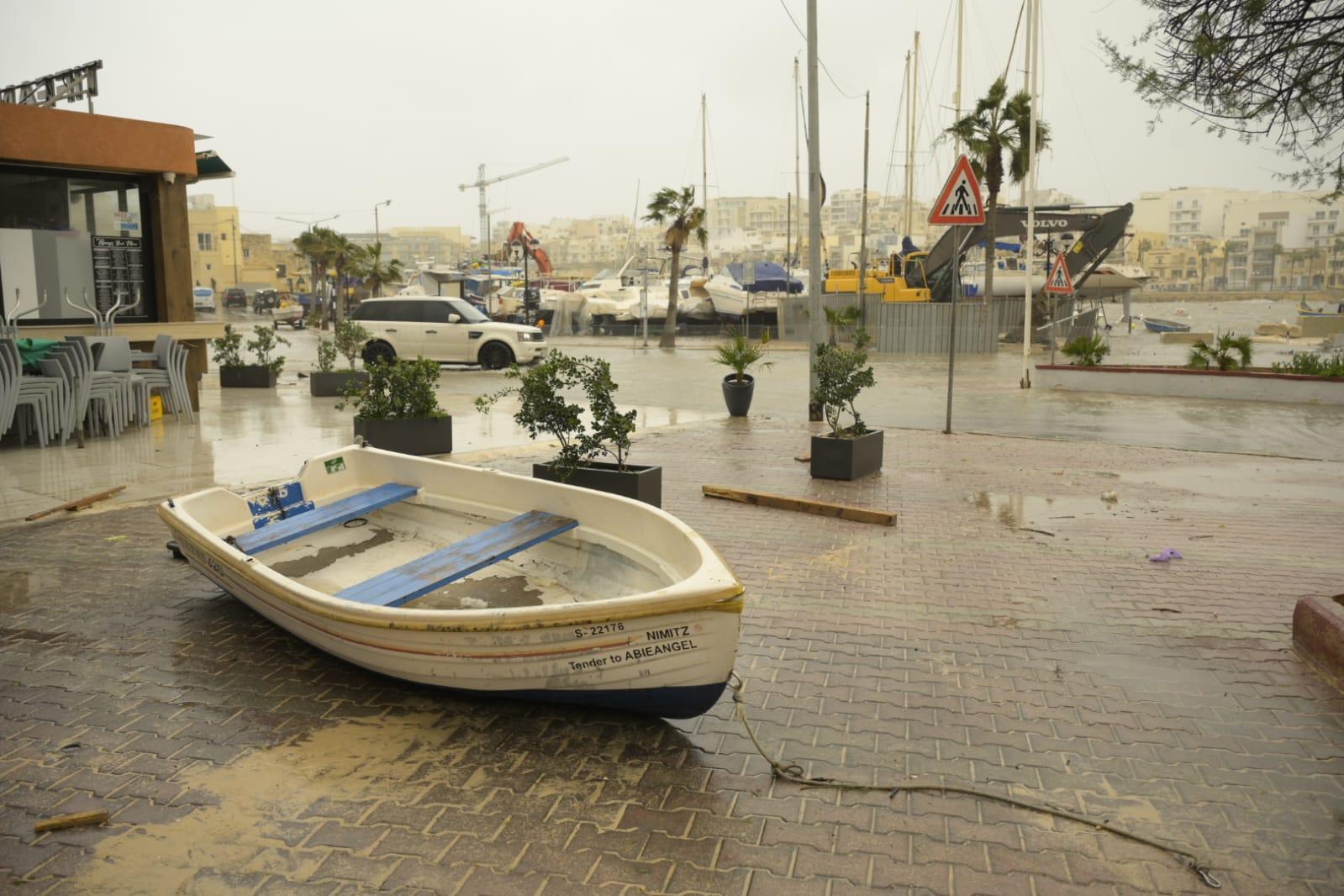 A small fishing boat ended up on the Marsascala promenade, along with debris and sand. Photo: Matthew Mirabelli