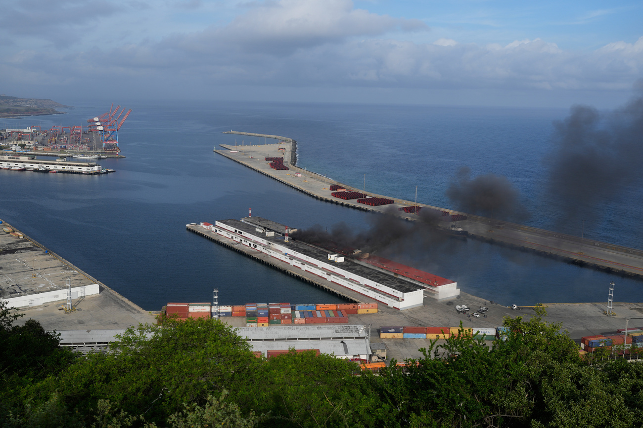 Smoke rises from a dock after explosions were heard at La Guaira port, Venezuela, Saturday, Jan. 3, 2026.