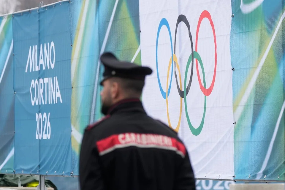 A Carabiniere paramilitary police officer patrols, the entrance of the Olympic Village, in Milan, Italy, Thursday, Jan. 29, 2026. 