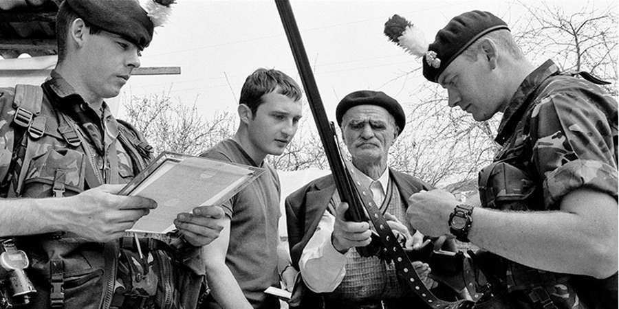 Soldiers in discussion with civilians.