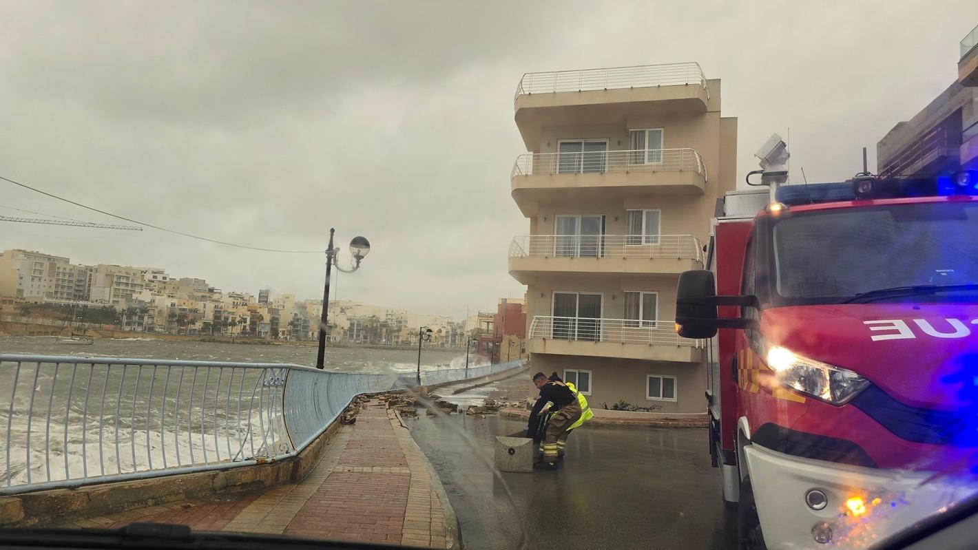 A member of the Civil Protection Department helps remove debris from the road in Marsascala. Photo: CPD
