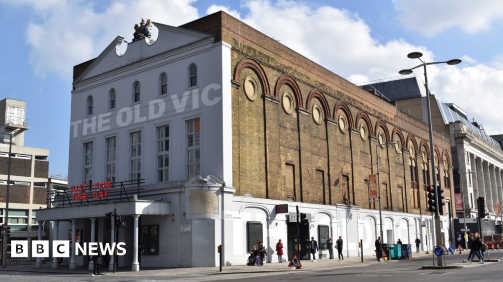 The Old Vic theatre - a large brick building which as a canopy held up by columns on the front. The Old Vic is written across the face of the building