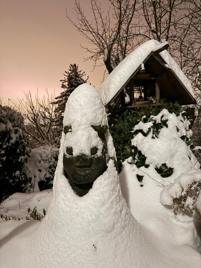 Dol Hareubang from Jeju Island, peacefully resting under a blanket of snow Dol Hareubang from Jeju Island, peacefully resting under a blanket of snow