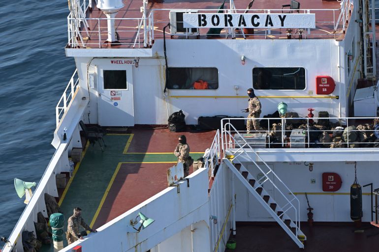This aerial picture taken on October 1, 2025 off the coast of the western France port of Saint-Nazaire shows French soldiers onboard the tanker from Russia's so-called "shadow fleet" suspected of being involved in drone flights over Denmark which sailed off the Danish coast between September 22 and 25. Named the Pushpa or Boracay, the Benin-flagged vessel, which is blacklisted by the European Union for being part of Russia's sanction-busting "shadow fleet", has been immobilised for several days off the French coast. (Photo by Damien MEYER / AFP)