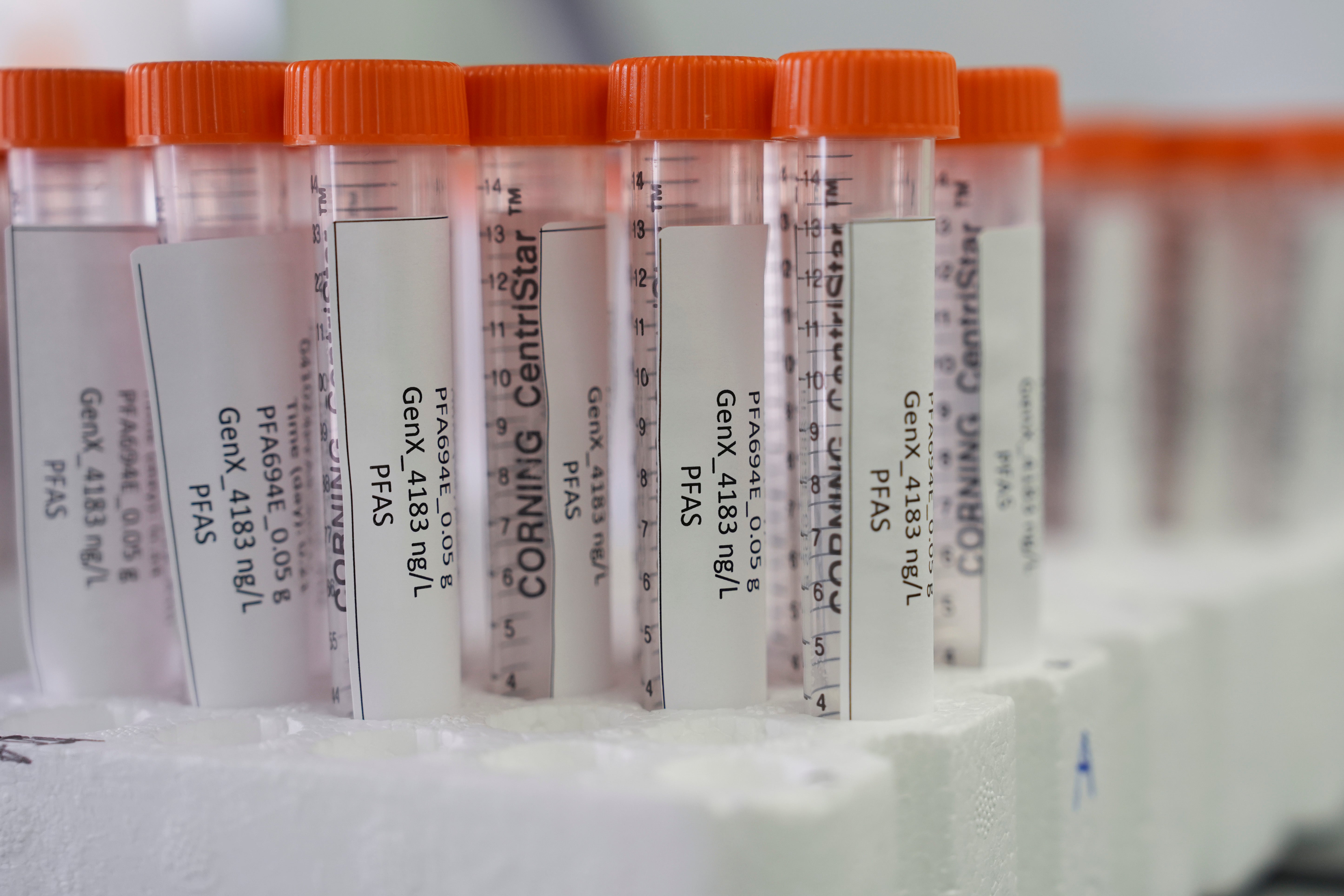 Vials containing samples of forever chemicals, known as PFAS, sit in a tray at a US Environmental Protection Agency lab
