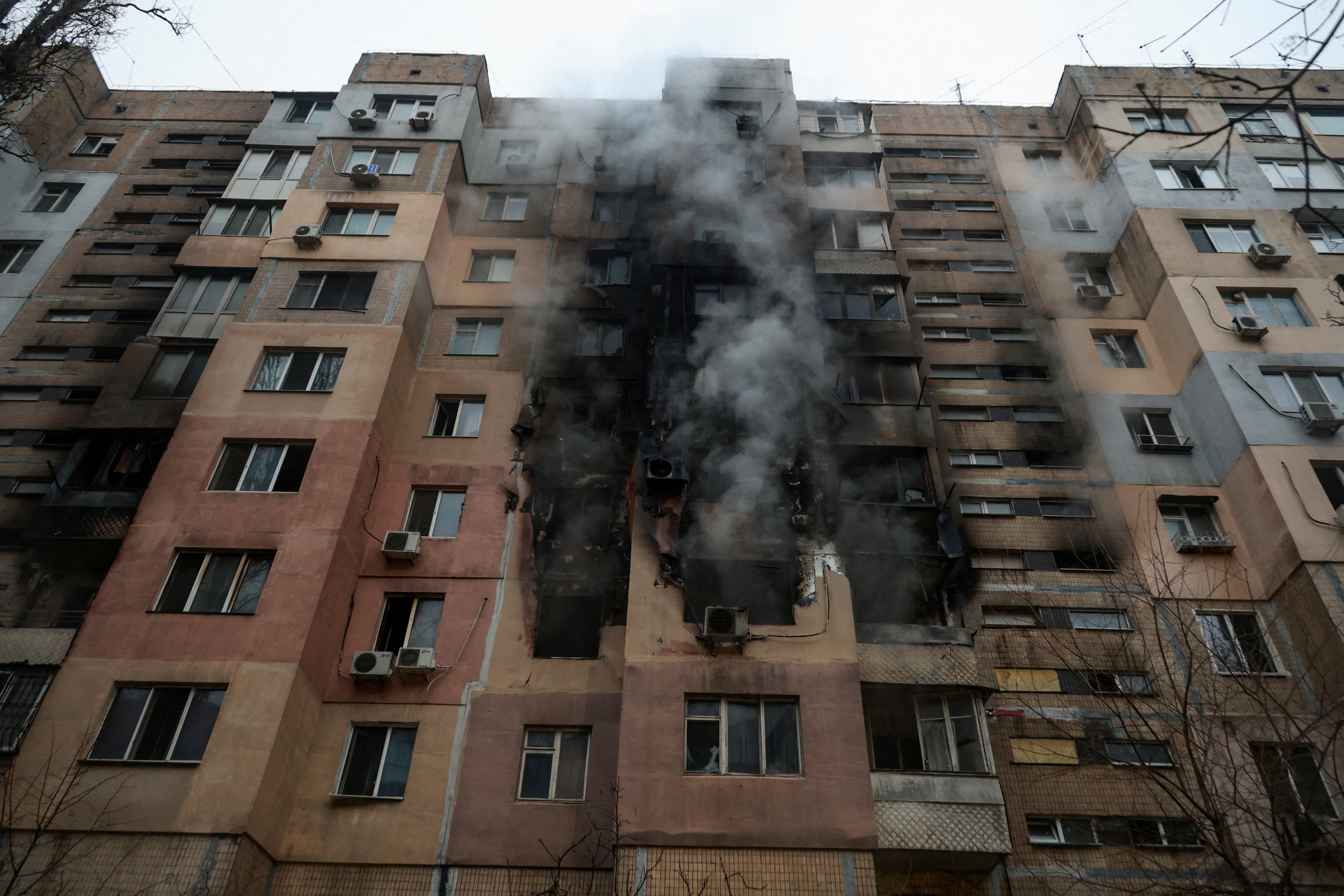 Smoke rises from an apartment building after it was hit during overnight Russian drone strikes, amid Russia's attack in Odesa,