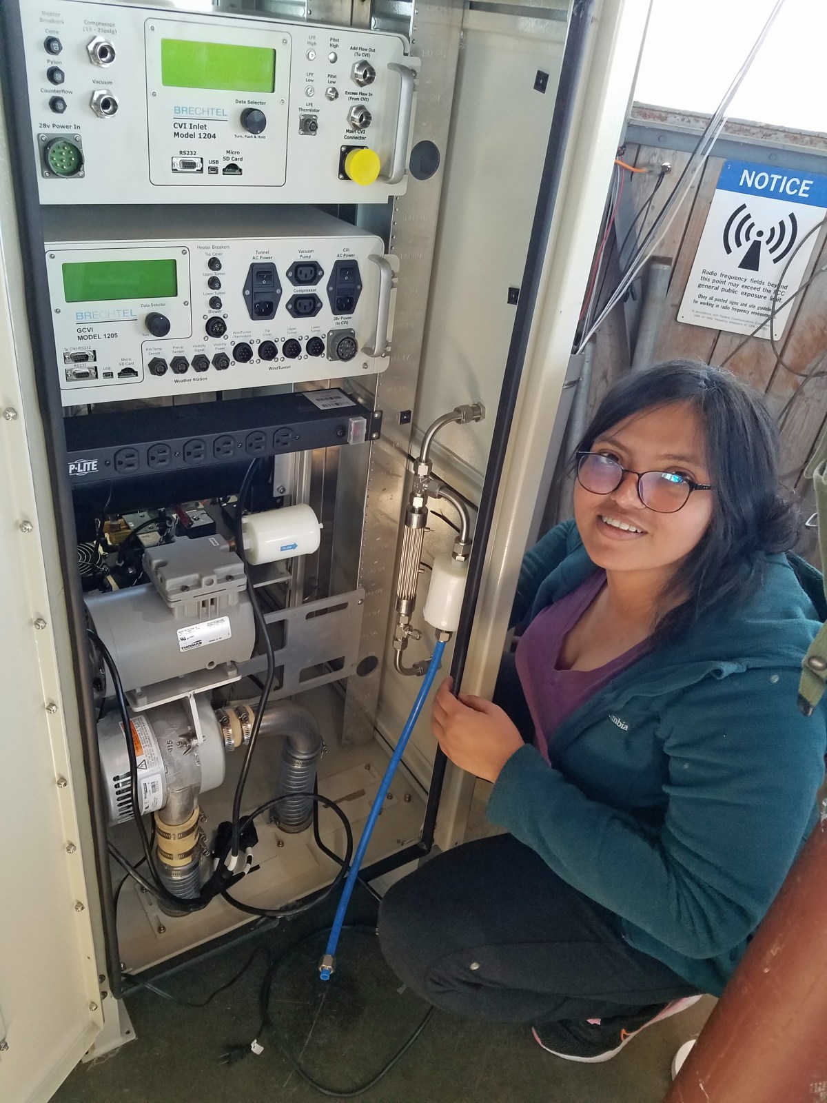 UAlbany PhD student Archana Tripathy re-assembles new equipment for sampling cloud droplet residuals (the particulate matter left behind when cloud droplets evaporate) after having brought individual components up a ladder and through a hatch to the top floor of the atmospheric research observatory at the summit of Whiteface Mountain. Photo Courtesy of ASRC
