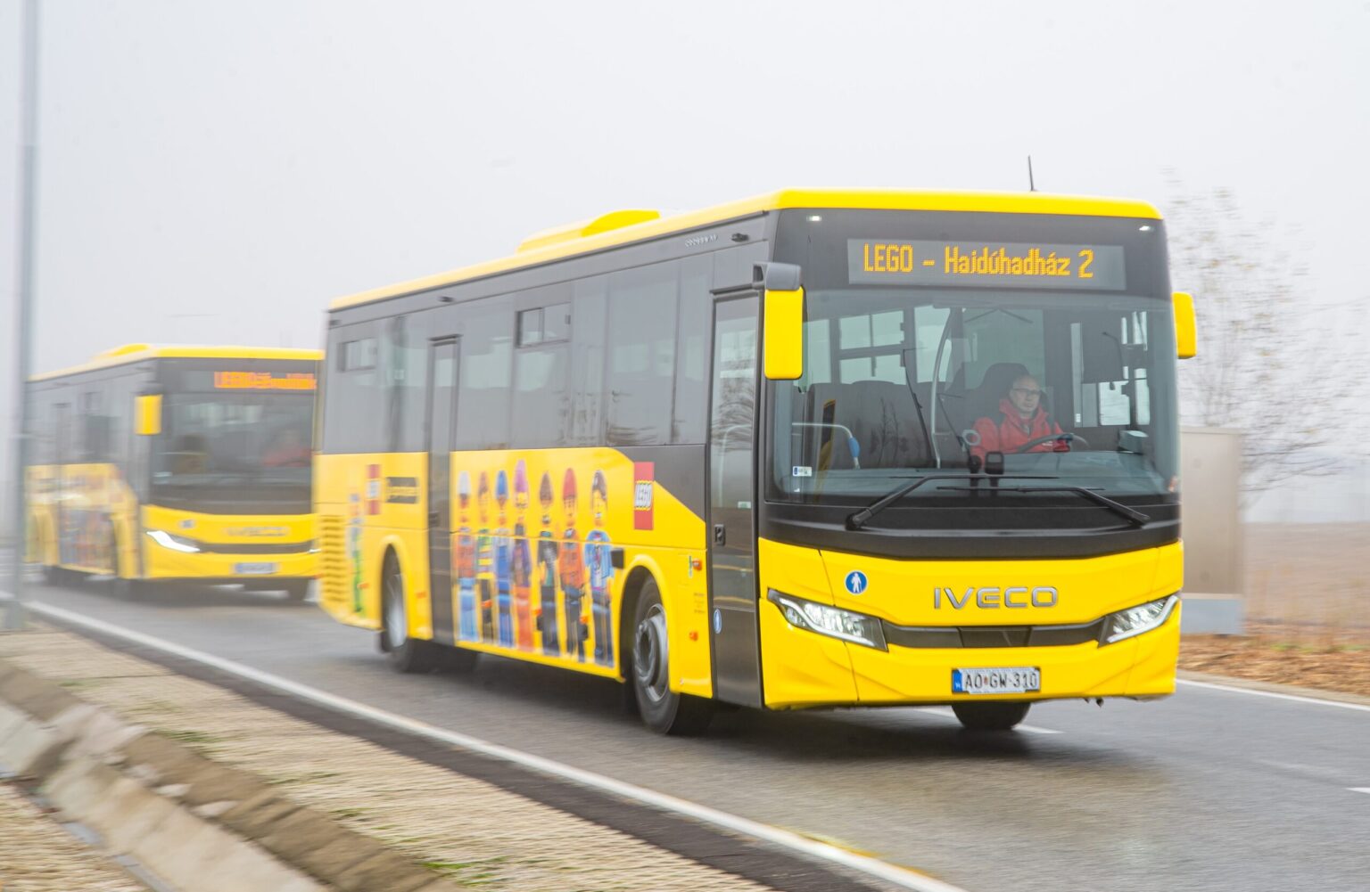 A yellow bus with LEGO people on the side