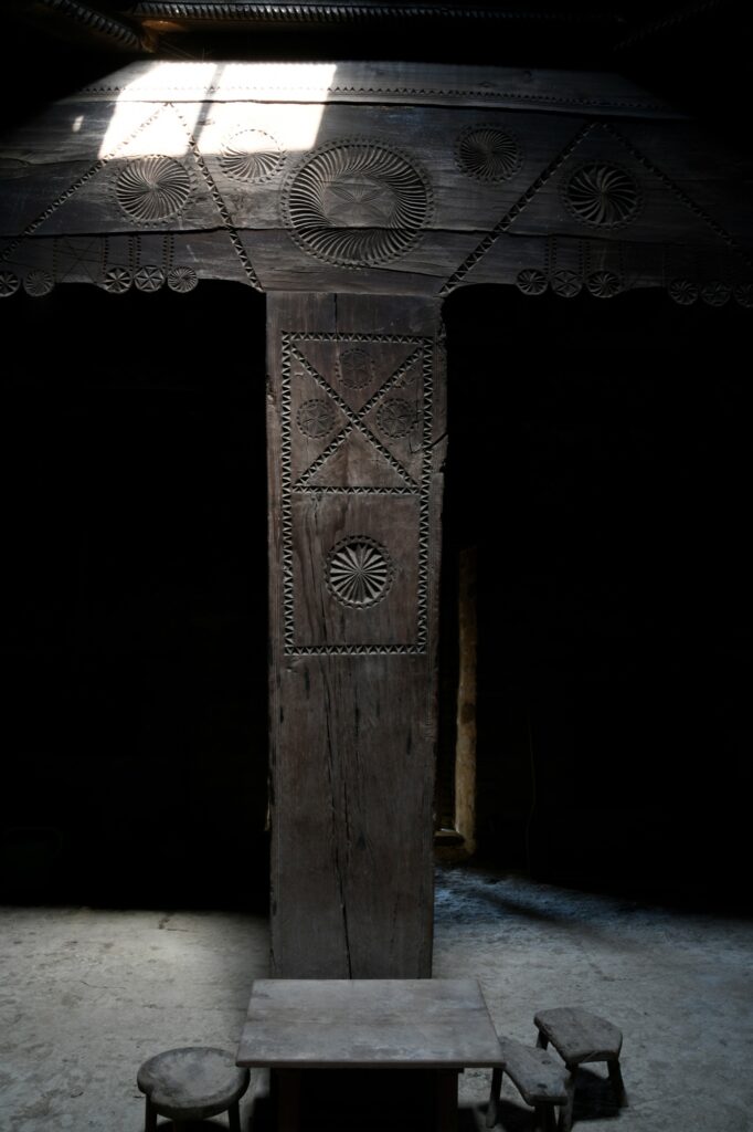 A wooden pillar with carvings