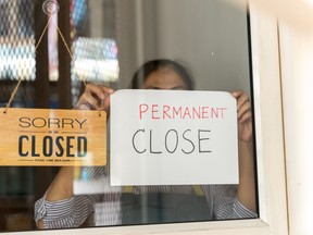 Restaurant owner posts permanent close sign.