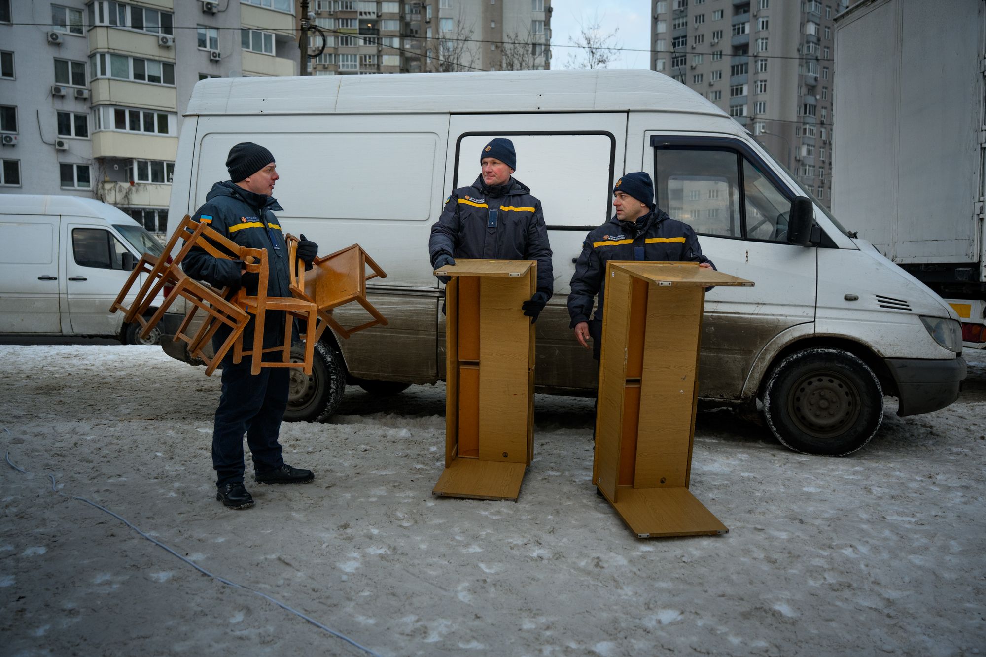 State Emergency Service workers bring furniture into additional emergency heating points set up that day in Desnianskyi district amidst the heating crisis caused by Russian air attacks, on January 25, 2026 in Kyiv, Ukraine