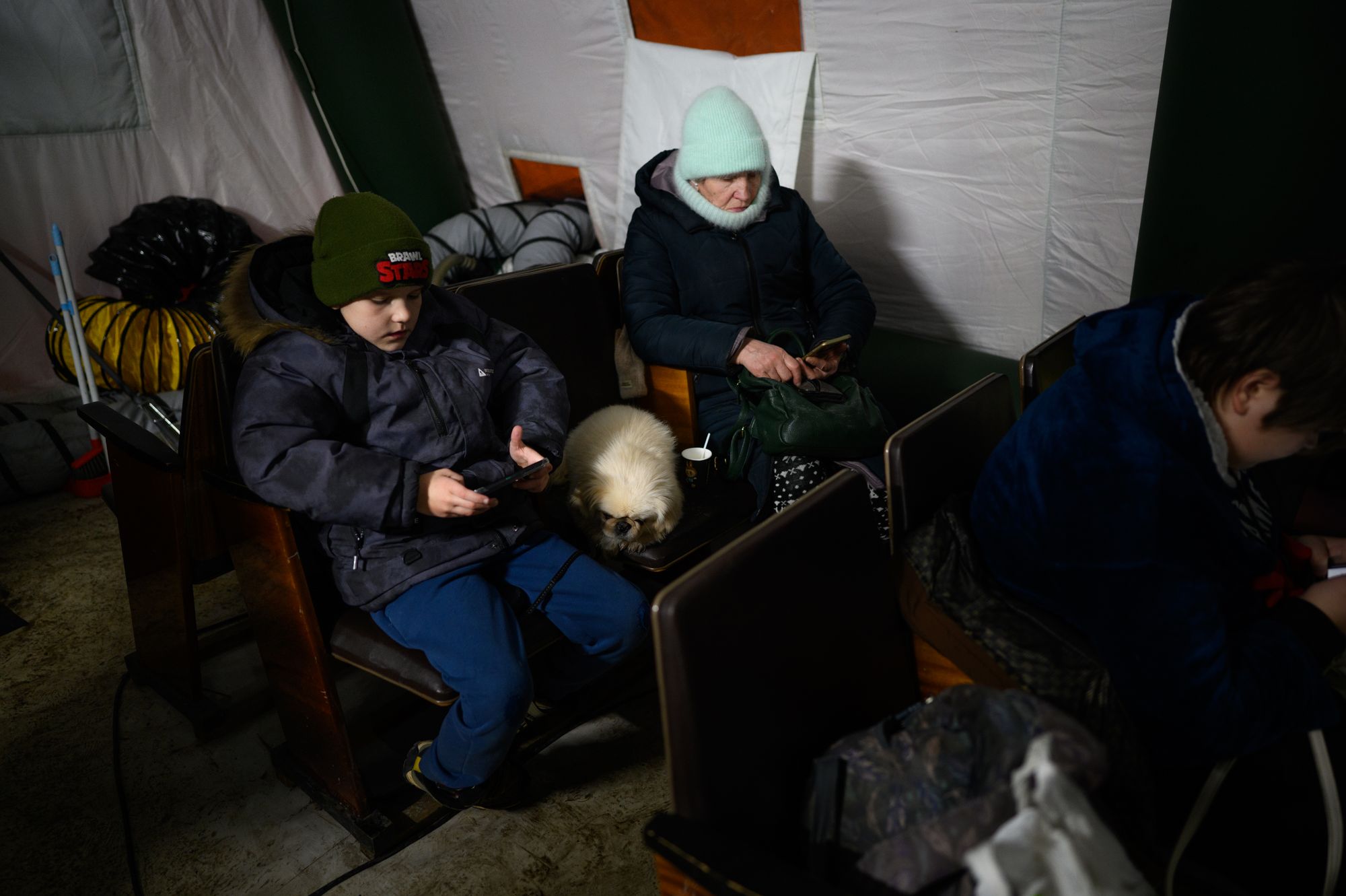 Residents of the Desnianskyi district of Kyiv, who lost electricity and heat due to air attacks, wait in a mobile heating point set up in their neighborhood, on January 25, 2026, in Ukraine
