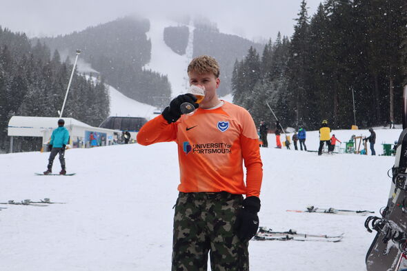 Charles Wade-Palmer drinking beer in snow