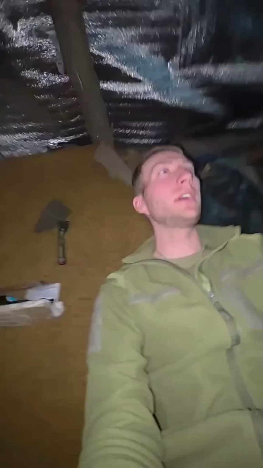 A Ukrainian soldier shows the difference between the cat and the dog living in their barracks.